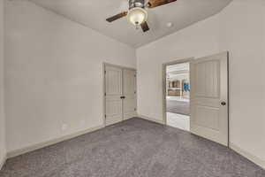Unfurnished bedroom with light colored carpet, a closet, and ceiling fan