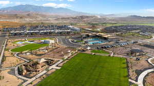Aerial view of residential area with a pool and a mountain backdrop