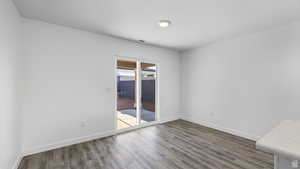 Unfurnished room featuring wood finished floors and baseboards