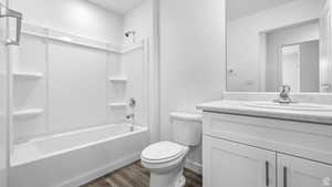 Bathroom with shower / tub combination, vanity, and dark wood-type flooring