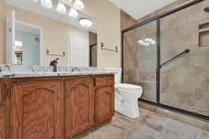 Bathroom featuring a shower stall and vanity