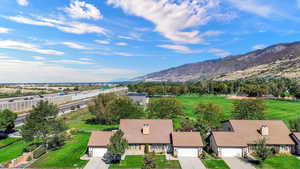 Aerial view of property and surrounding area with a mountain backdrop