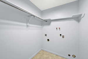 Washroom with washer hookup, light tile patterned floors, and hookup for an electric dryer