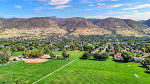 View of mountain backdrop featuring nearby suburban area
