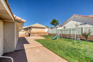 Fenced backyard with a playground