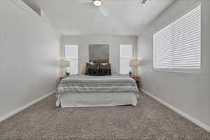 Bedroom with carpet, a ceiling fan, and a textured ceiling