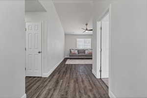 Hall featuring dark wood finished floors and baseboards