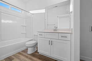 Bathroom featuring shower / bath combination, dark wood-type flooring, and vanity