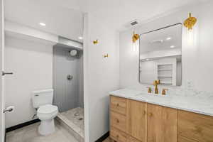 Full bathroom featuring vanity, tiled shower, recessed lighting, and light tile patterned floors