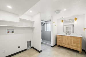 Bathroom with vanity, a shower stall, recessed lighting, and light tile patterned floors