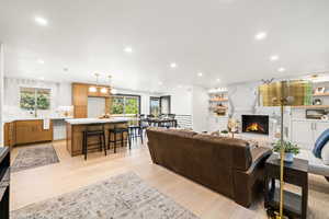 Living area with a premium fireplace, recessed lighting, and light wood-type flooring