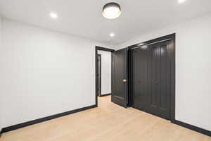 Unfurnished bedroom 3 featuring light wood-style floors, a closet, and recessed lighting