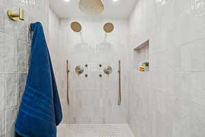 Master bathroom featuring a tile shower