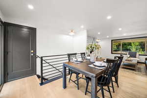 Dining space with recessed lighting and light wood-type flooring