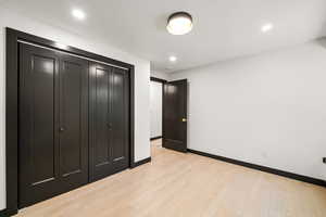 Unfurnished bedroom 2 with a closet, light wood-style flooring, and recessed lighting