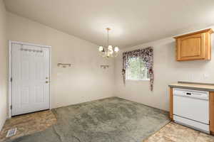 Unfurnished dining area with vaulted ceiling and a chandelier