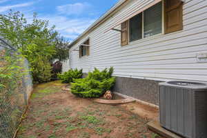 View of property exterior with a central AC unit