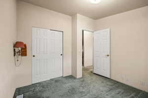 Unfurnished bedroom with carpet and a closet