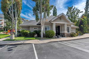 View of building exterior with uncovered parking