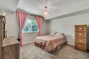 Bedroom featuring carpet floors and a chandelier