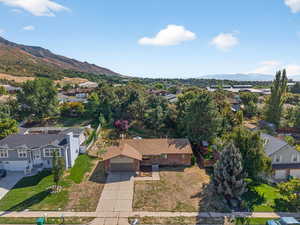 Aerial perspective of suburban area featuring a mountainous background