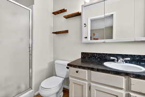 Bathroom featuring vanity and a stall shower
