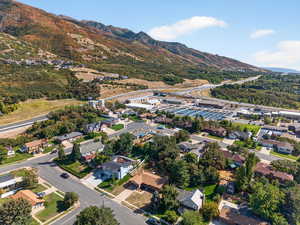Aerial overview of property's location with a mountainous background and nearby suburban area