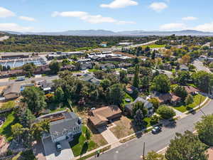 Aerial overview of property's location with nearby suburban area and a mountainous background