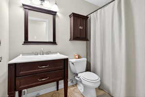 Full bath with vanity, light tile patterned floors, and a shower with shower curtain