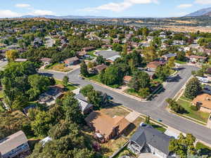 Aerial view of property's location featuring a mountain backdrop and nearby suburban area