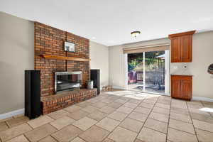 Unfurnished living room with a brick fireplace and a textured ceiling