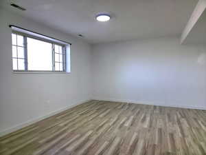 Unfurnished room featuring light wood-type flooring and baseboards