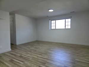 Unfurnished room with light wood-style flooring and baseboards