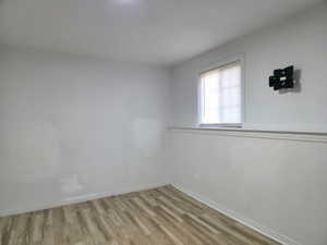Unfurnished room featuring baseboards and light wood-style flooring