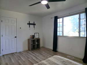 Bedroom with light wood finished floors and ceiling fan