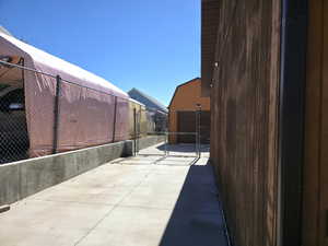 View of patio featuring a gate