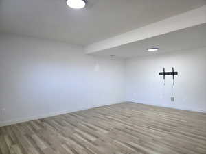 Unfurnished room featuring light wood-type flooring and baseboards