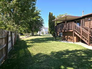 View of yard featuring a deck and stairway