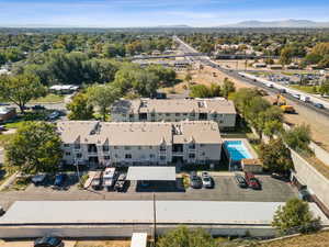 Drone / aerial view of a mountainous background and apartment complex / building