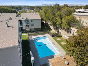 Community pool featuring a fenced backyard, a patio, and a mountain view