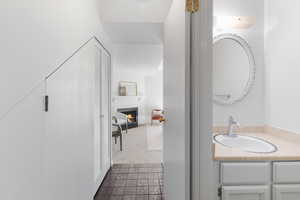 Bathroom with vanity and a fireplace with flush hearth