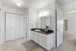 Bathroom featuring vanity and baseboards