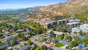 Aerial view of property and surrounding area with a mountainous background