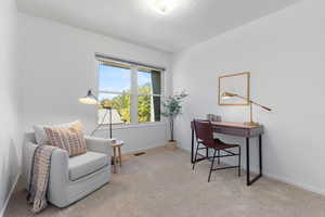 Home office featuring light carpet and baseboards