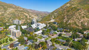 Aerial view of property and surrounding area featuring a mountain backdrop
