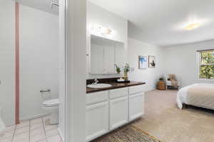 Bedroom with light carpet and light tile patterned floors