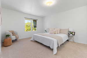 Carpeted bedroom featuring baseboards
