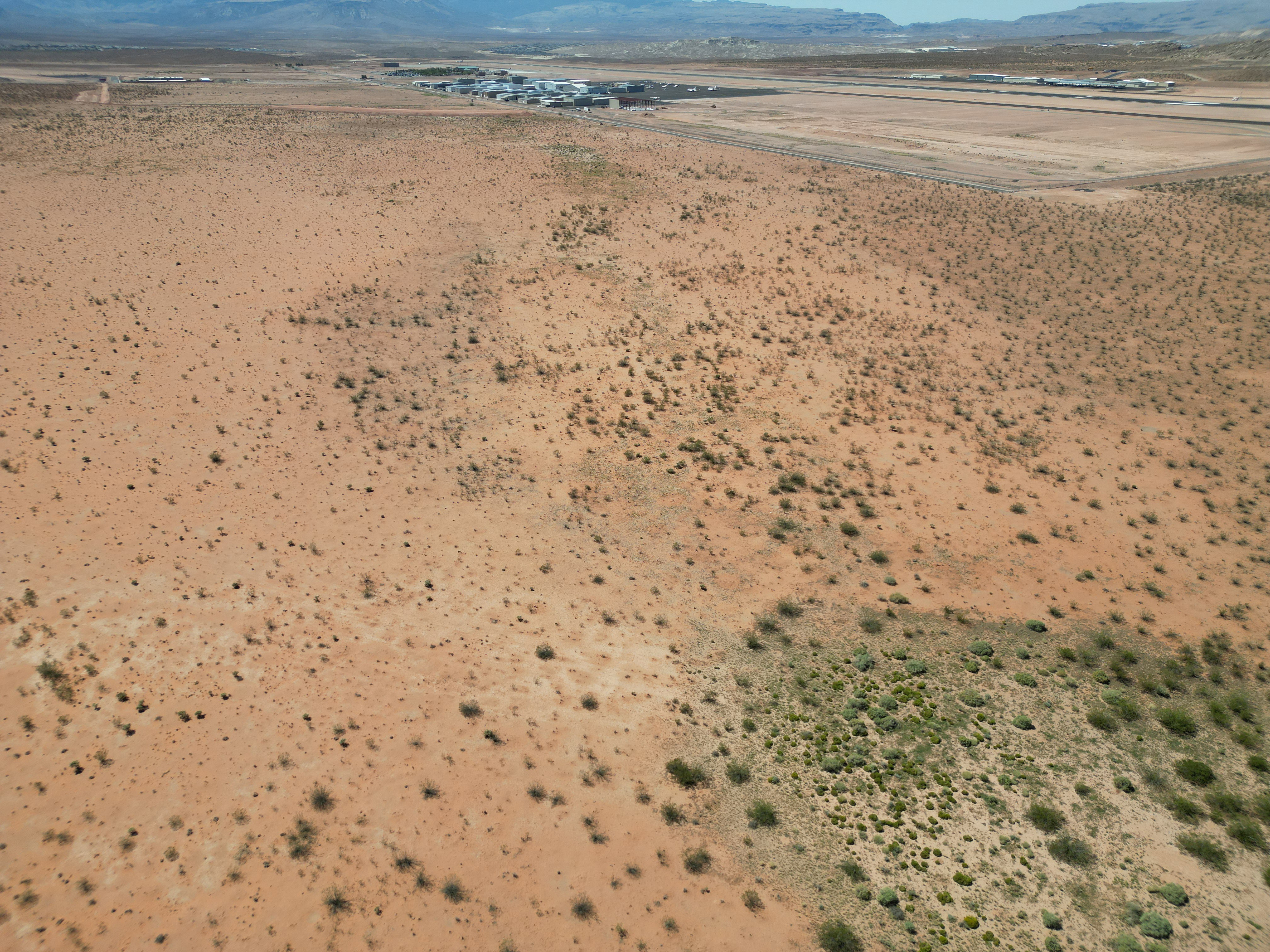 Overview of rural landscape with a mountain backdrop and a desert landscape