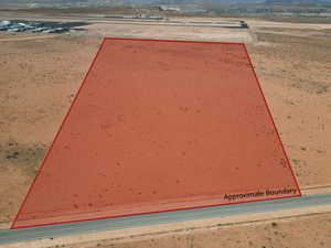 Entry to storm shelter with view of desert landscape and a mountain view
