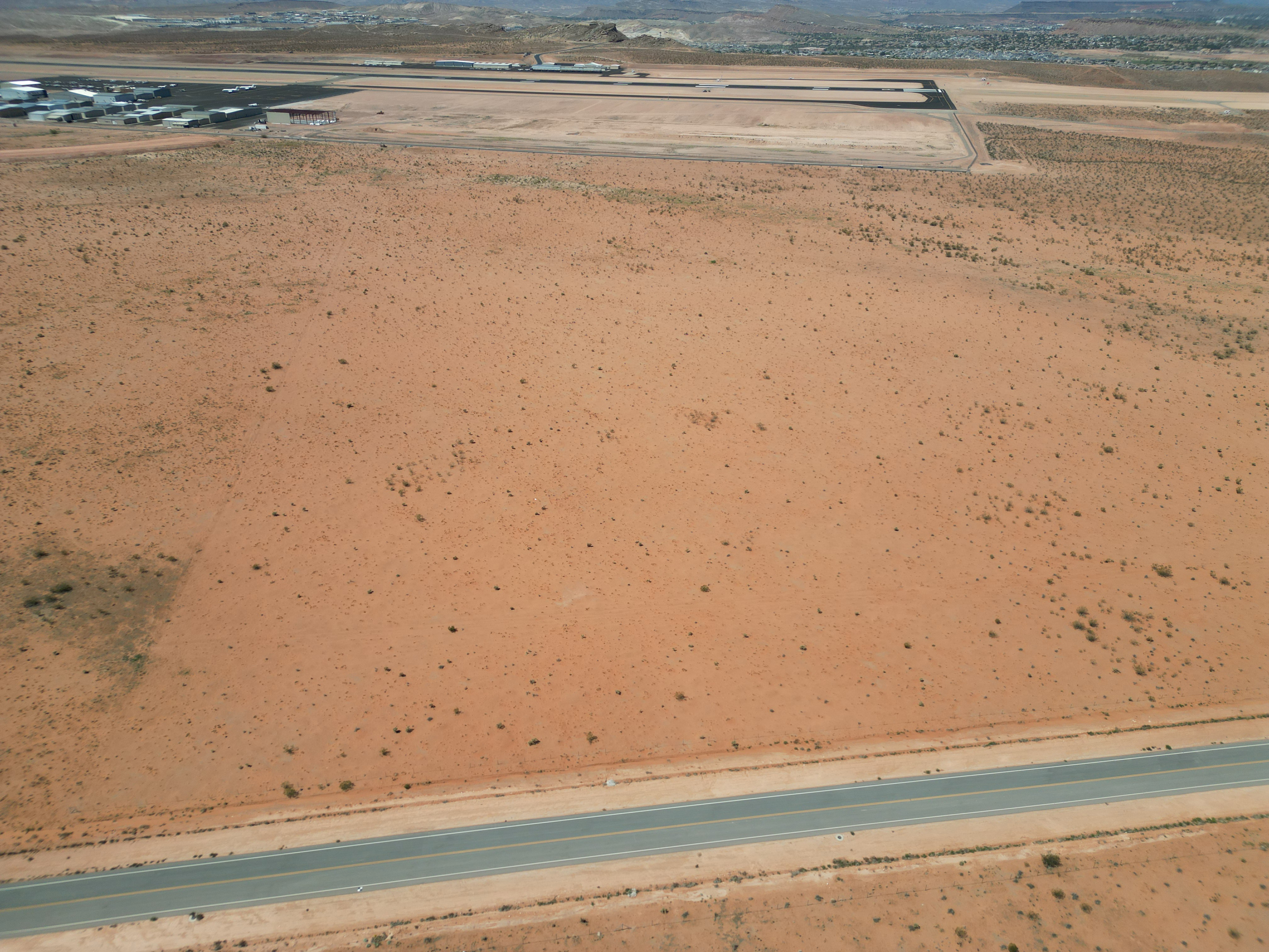 Drone / aerial view of a desert landscape and a mountain backdrop